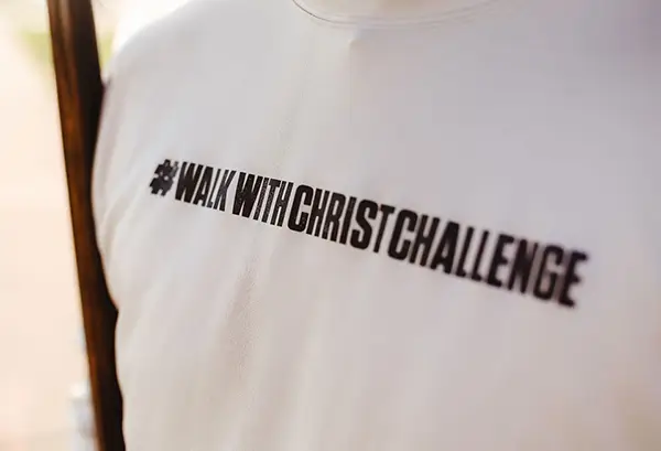 Closeup of a t-shirt with the hash tag #walkwithChristchallenge